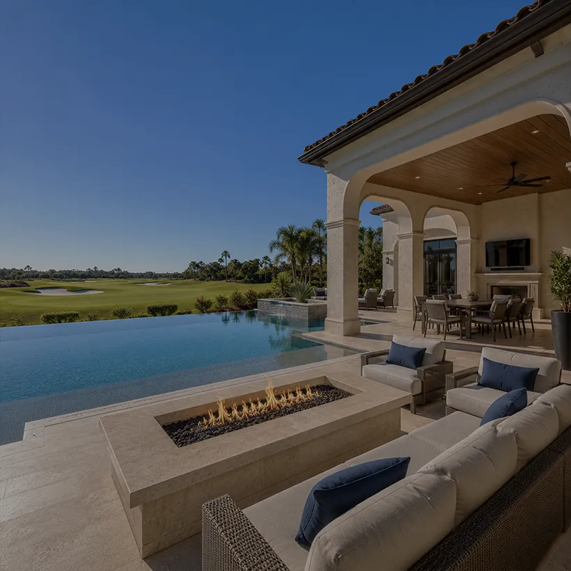 Pool and outdoor living area overlooking the golf course at a Quail West home in Naples, Florida