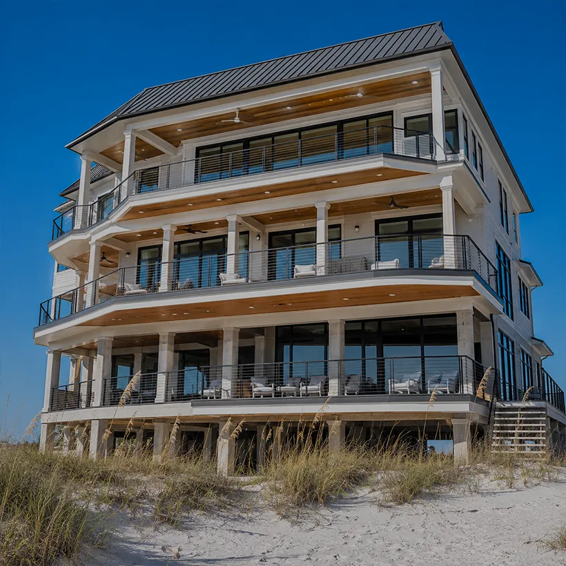 Beachfront home with stacked balconies rising above the dunes at Barefoot Beach, Naples, Florida