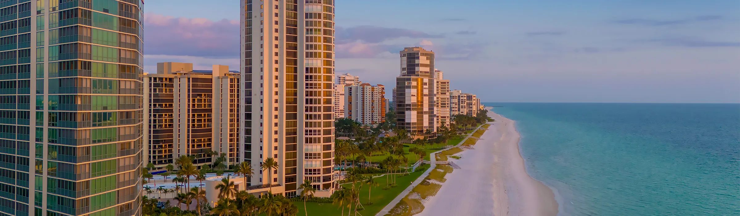 Condominium towers along the beach on the Gulf of Mexico in Naples, Florida, at sunset