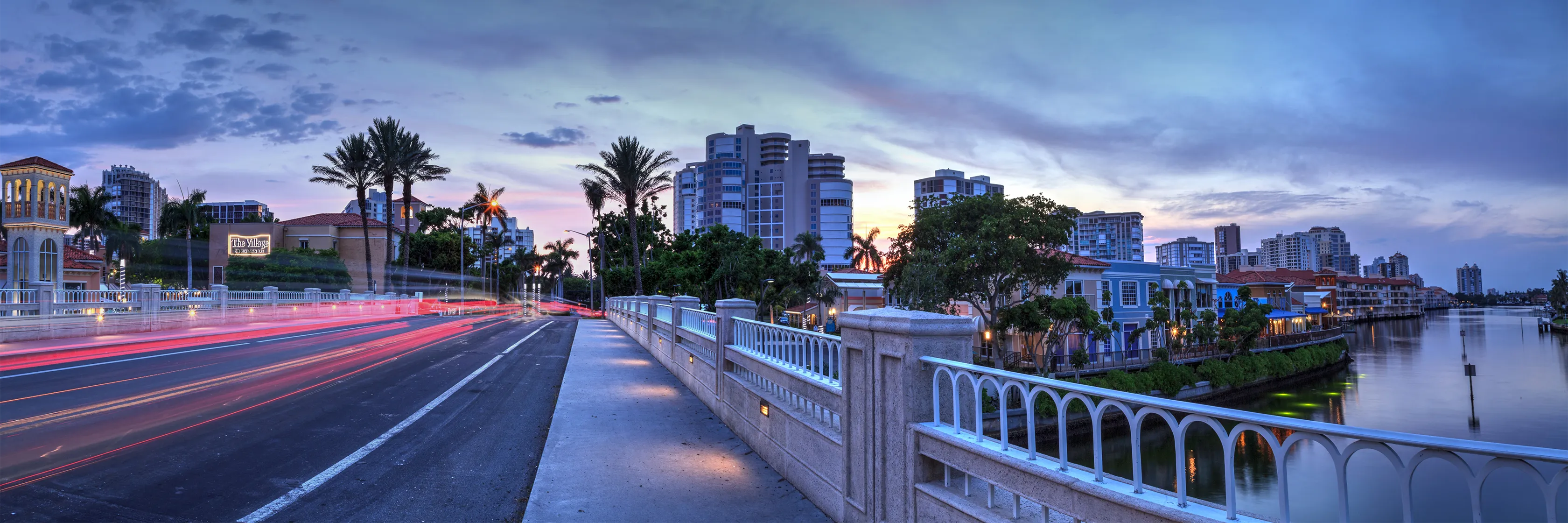 Gulf Shore Boulevard bridge at dusk beside The Village on Venetian Bay in Park Shore, Naples, Florida