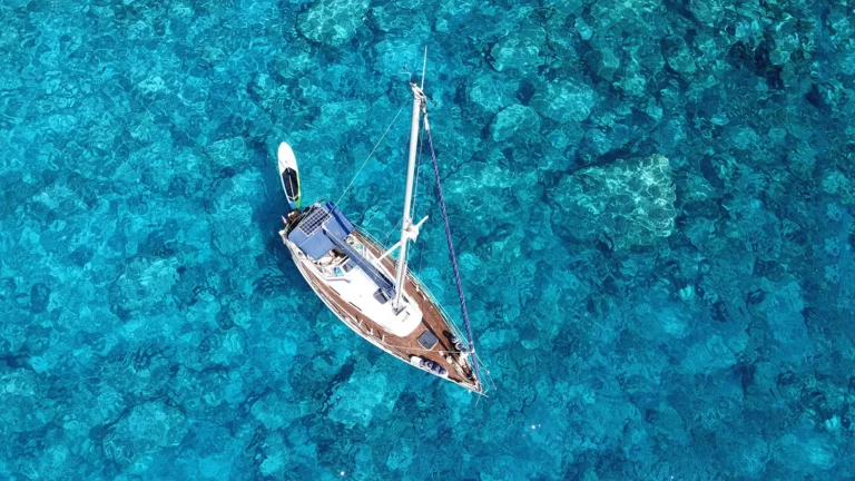 A sailboat anchored off Naples, FL on a sunny day.