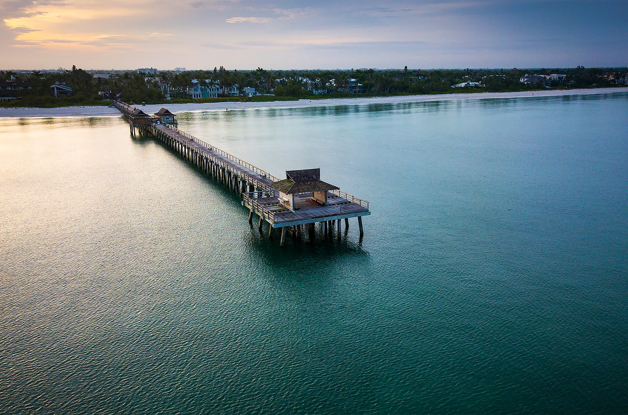 The Naples Pier at dusk, a few minutes north of Port Royal on the Gulf beach in Old Naples, Florida